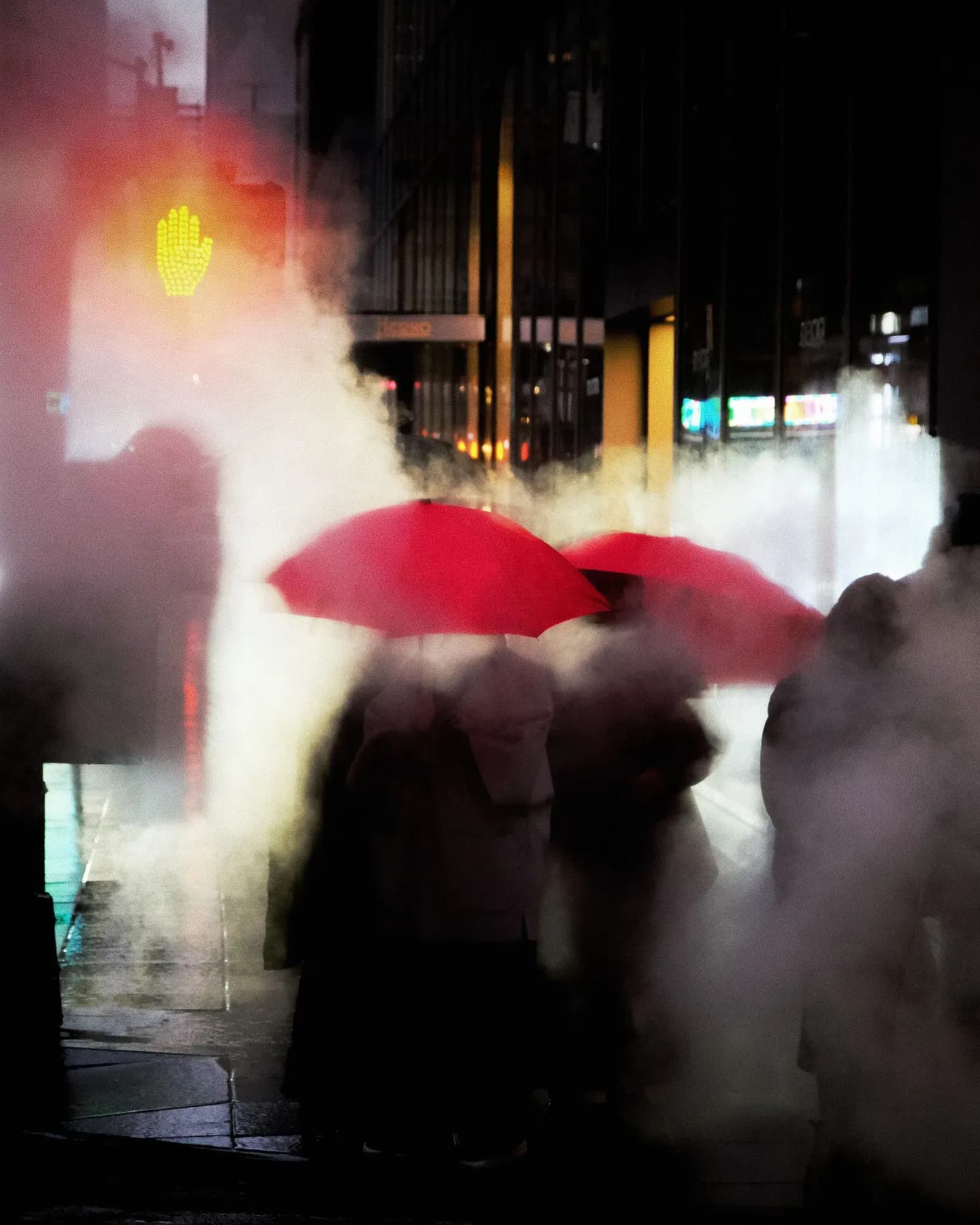 Two red umbrellas in a cloud of street steam at night, by Alex Zarnoski